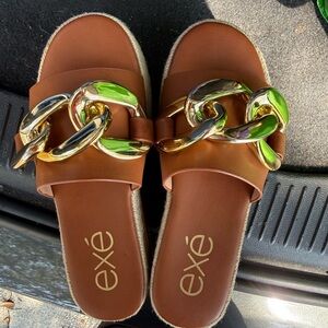 Exé Brown Slide Mules with Gold Chain Accent